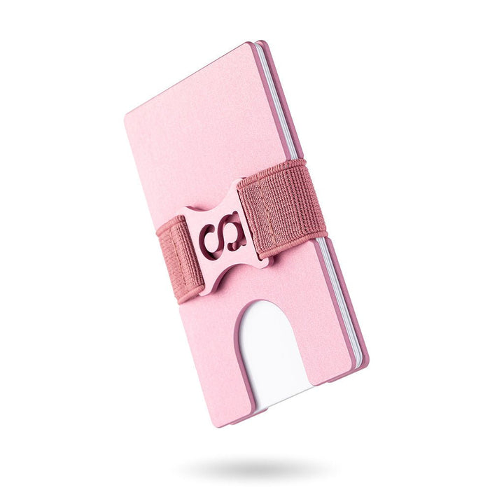 a pink cell phone sitting on top of a table 